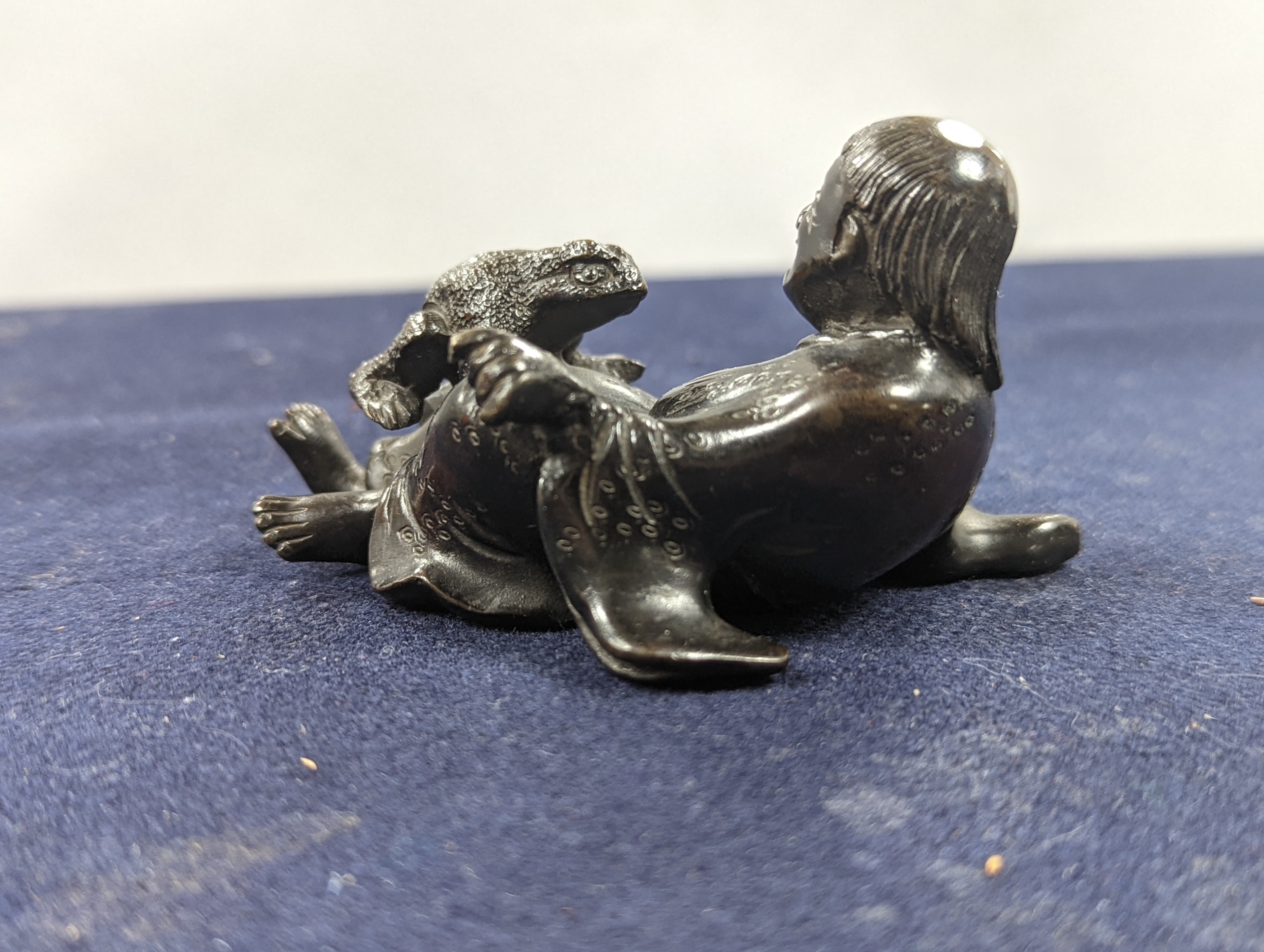 A Chinese bronze group of Liu Hai and a toad, wood stand and a bronze figure of a dog, 9cm